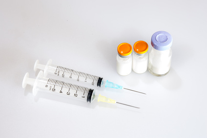 The Syringe and vaccine on white background