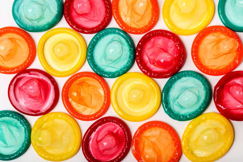 Colorful condoms on a white background